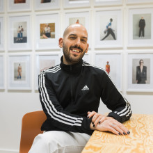 Caleb Spahr sitting at a table, smiling at the camera