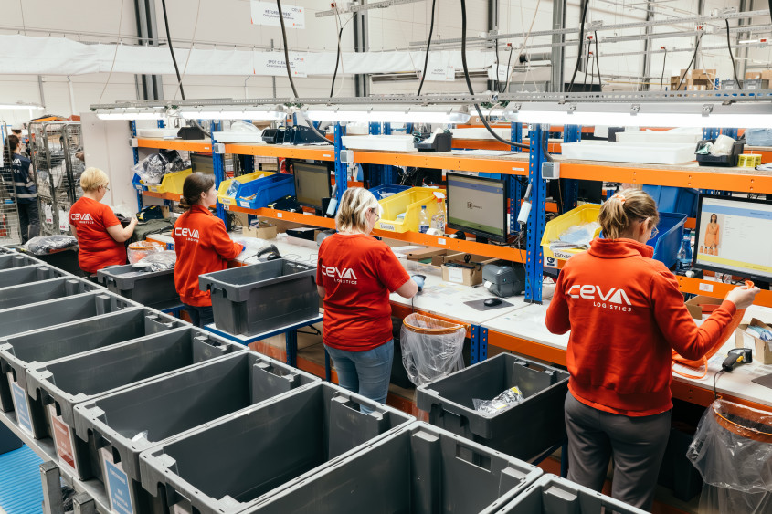 A row of workers at logistics work stations